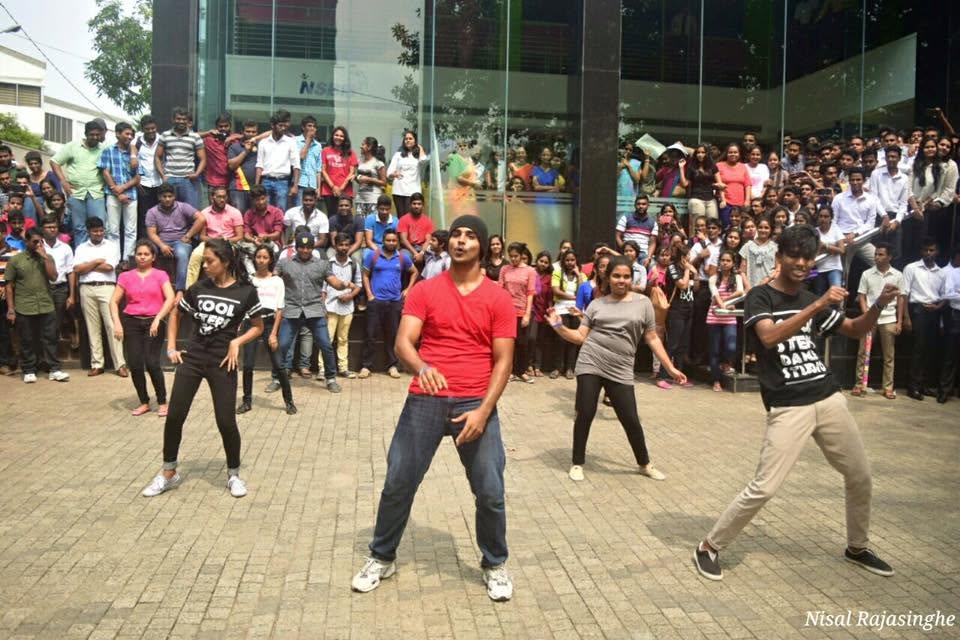 Piumal leading a flash-mob dance in front of a crowd