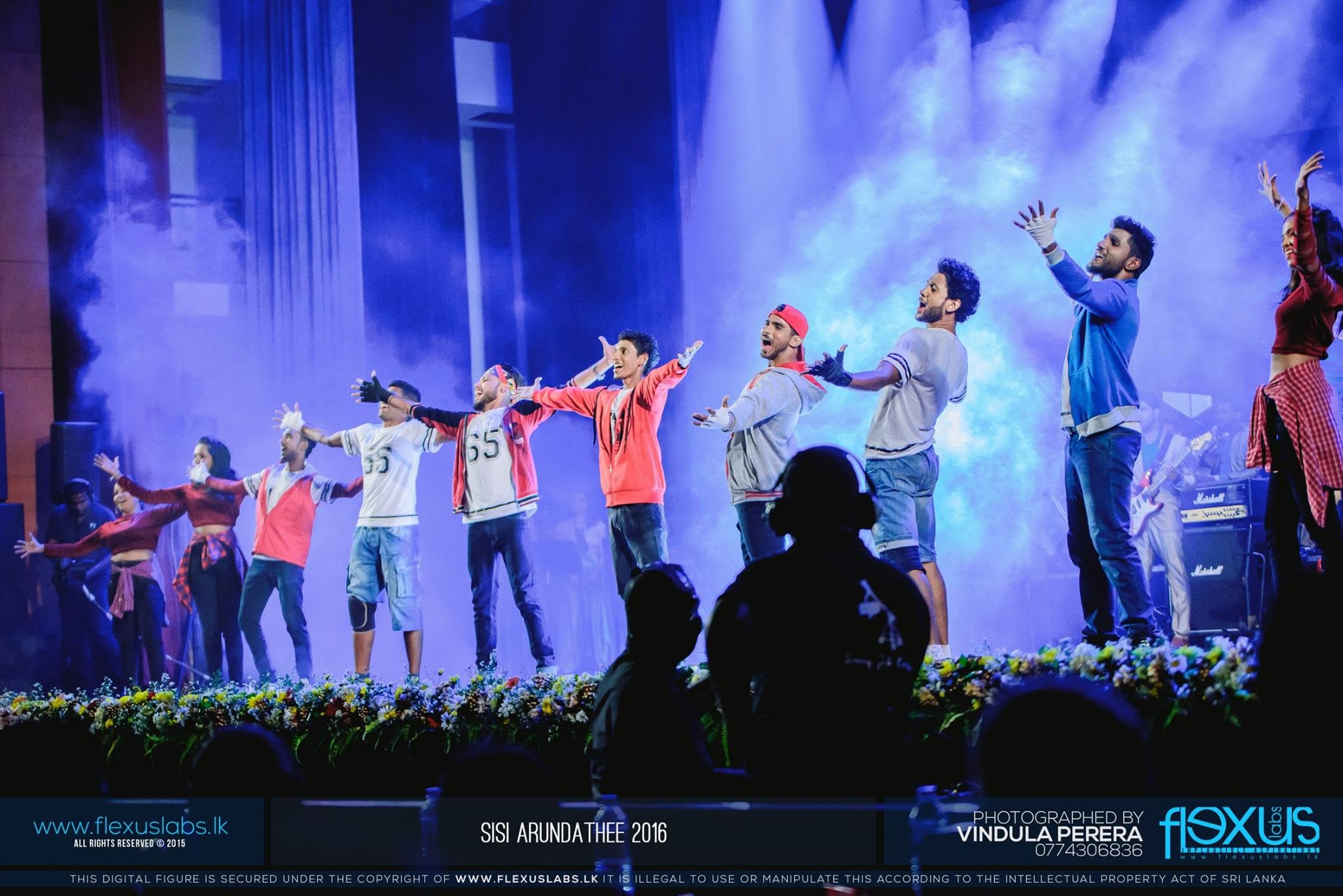 Piumal performing with a dance ensemble on stage
